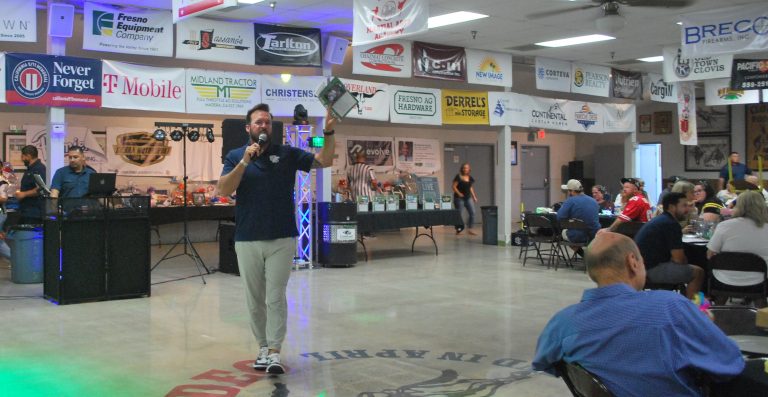 Emcee, CEHS Baseball Director, and economics teacher Ryan Smith auctions items off at the CEHS football team fundraiser (Photo by Hannah-Grace Leece, Clovis Roundup).