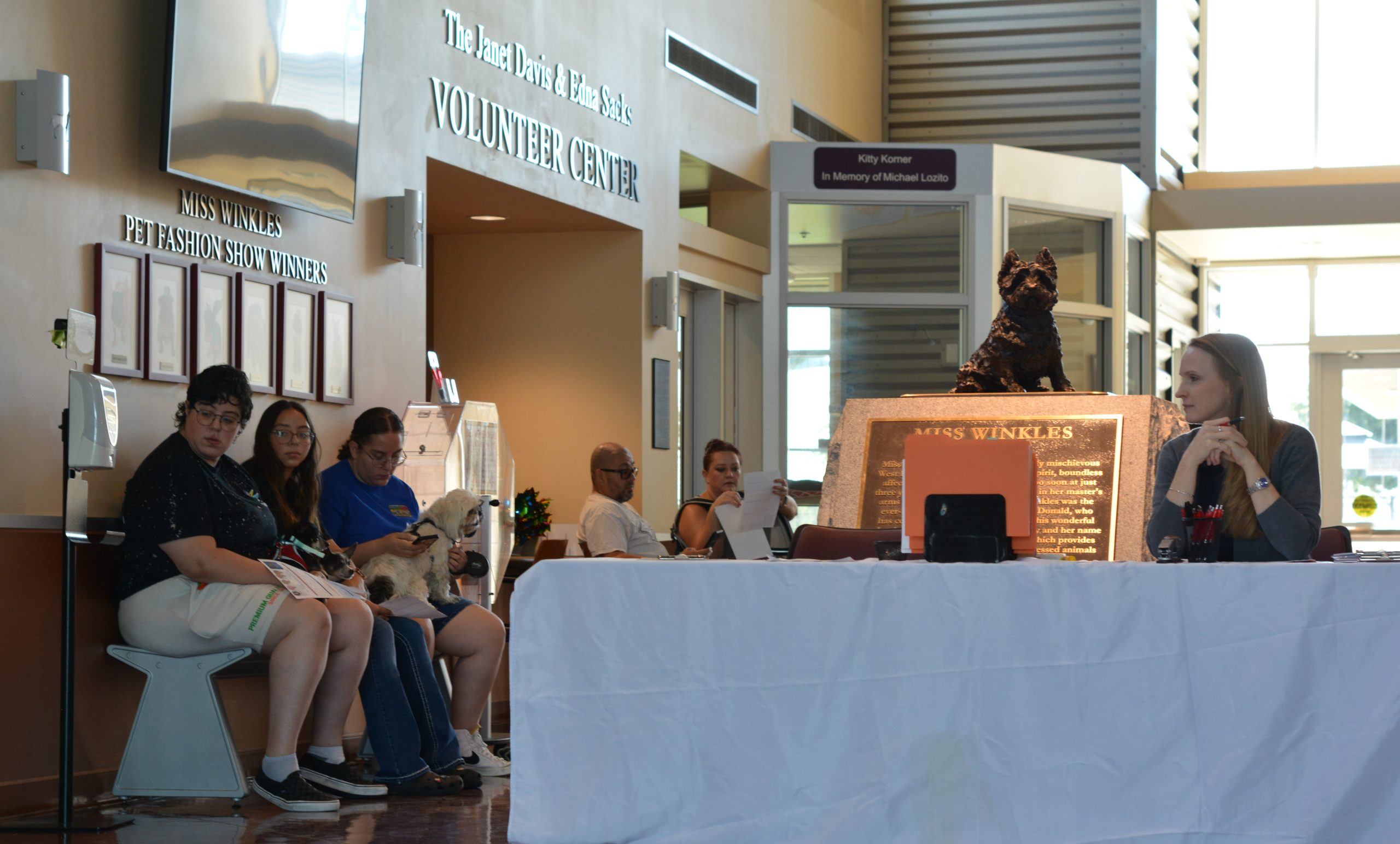 Pets and their owners wait patiently for their turn to get a microchip and their vaccinations.