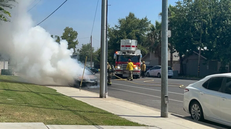 Firefighters put out a car fire on a Honda near the intersection of Barstow and Minnewawa (Photo by KMPH Fox 26 News).