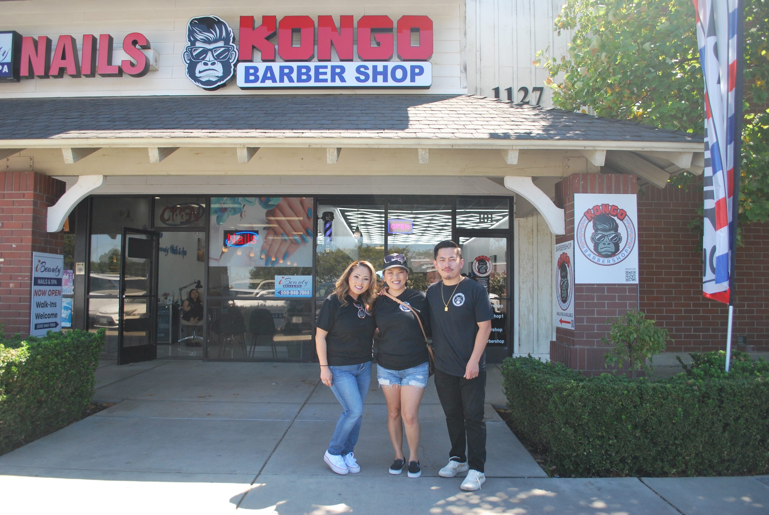 Kong Xiong, owner of Kongo Barbershop, with his sister-in-law Nancy Moua (left), and his wife Frances Moua (middle) (Photo by Hannah-Grace Leece, Clovis Roundup).