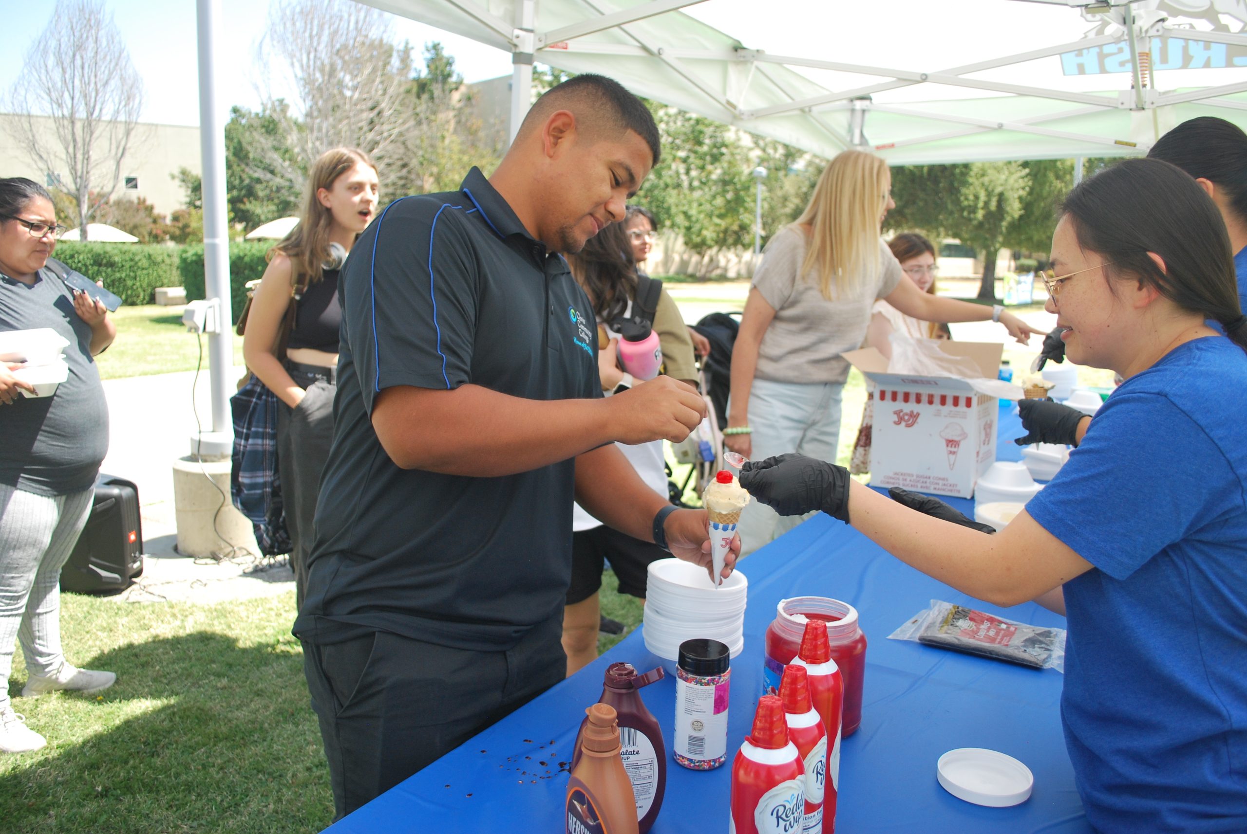 Student workers at Clovis Community College work diligently to give students free ice cream at the Live Like Molly / Day of Kindness event (photo by Hannah-Grace Leece, Clovis Roundup).