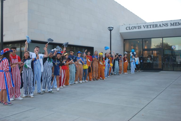 A crowd of CUSD students in their school colors welcomes attendees at the entrance to the Clovis Veterans Memorial District building for the annual State of the District meeting on October 3, 2024 (photo by Hannah-Grace Leece, Clovis Roundup).